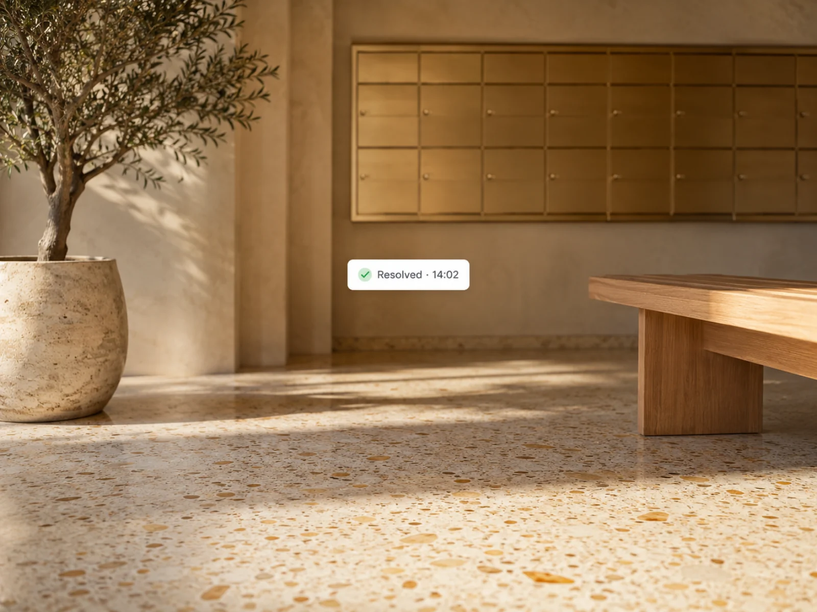 A quiet condo lobby corner with a resolved status chip floating in the negative space